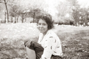 Black and White Photo of a Women sitting in a park